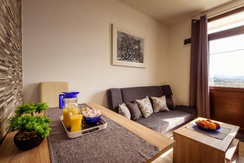 a living room with a couch and a table at Apartment Sea bass Neretva in Ploče