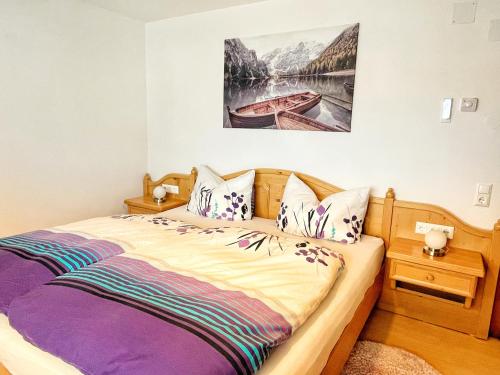 Schlafzimmer mit einem Bett mit Wandgemälde in der Unterkunft Bergzauber Obervellach im Mölltal in Obervellach