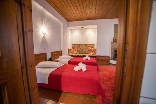 a bedroom with two beds with towels on them at Ξενώνας Πατρικό in Neraïdochóri