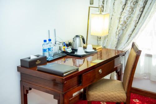 a desk in a hotel room with a telephone on it at Weston Hotel in Nairobi