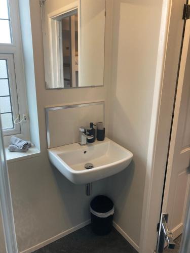 a bathroom with a sink and a mirror at Abbey Court Guest House in Carlisle