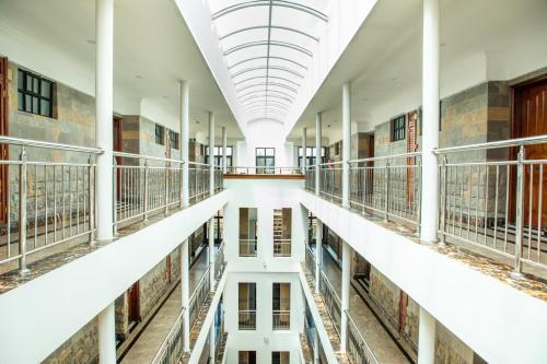 an empty hallway of a library with a reflection in the water at Weston Hotel in Nairobi