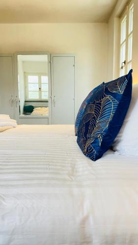 a large blue pillow sitting on top of a bed at Villa Arancia Quiet, Central, Parking and Air Conditioning in Levanto