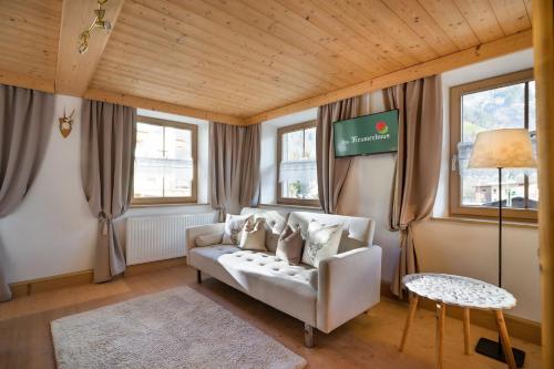a living room with a couch and a table at Das Krumerhaus in Aschau