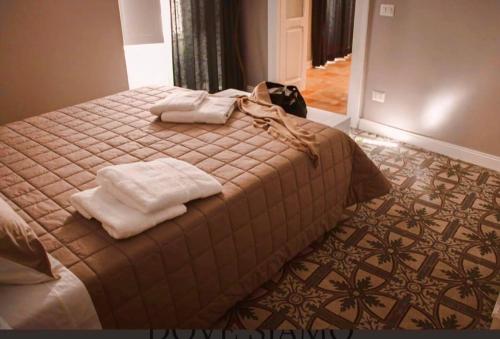 a bedroom with a bed with towels on it at Il Campanile Premium B&b in Altamura