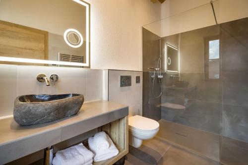 a bathroom with a sink and a toilet at Das Krumerhaus in Aschau
