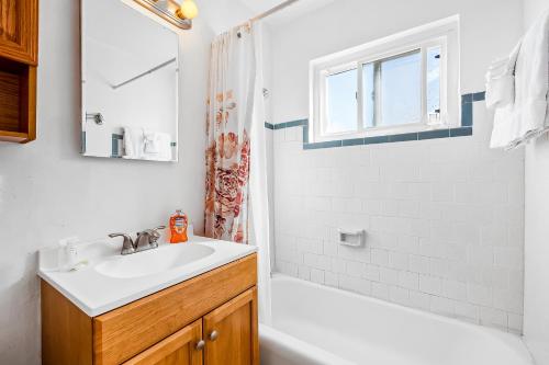 a white bathroom with a sink and a shower at Mimi's and Nana's Beach House in San Diego