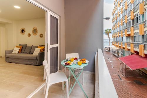 a living room with a table and a couch at Cozy Family Beach House in Las Palmas de Gran Canaria