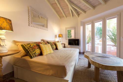 a bedroom with a bed with pillows and a table at Villa Domingues in Lisbon
