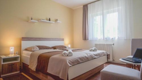 a bedroom with a bed with towels on it at Apartment Vlado in Poreč