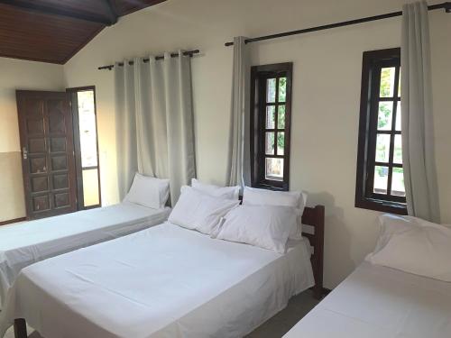 En eller flere senge i et værelse på Pousada Coração de Búzios
