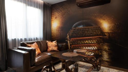 a living room with a leather couch and a table at HIDDEN BANK: Digger's Dream in Plovdiv