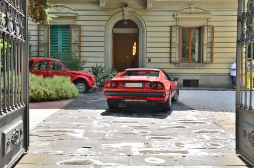 a red car parked in front of a house at Residence Michelangiolo in Florence