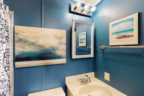 a blue bathroom with a sink and a toilet at North Point Condo 301 in Ocean City