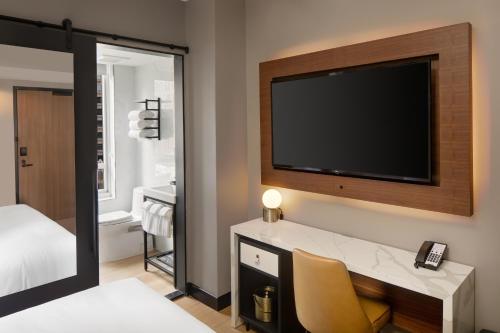 a hotel room with a television and a bed at Hotel Indigo - NYC Downtown - Wall Street, an IHG Hotel in New York