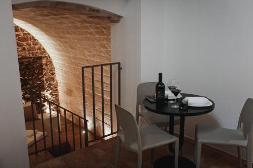 a dining room with a table and a stairway at Il Campanile Premium B&b in Altamura