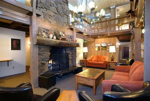 a large living room with a stone fireplace at Cristiana Guesthaus in Crested Butte