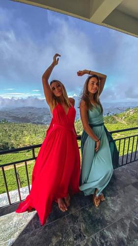 two women in dresses standing on a wall at leisure Mount View in Haputale