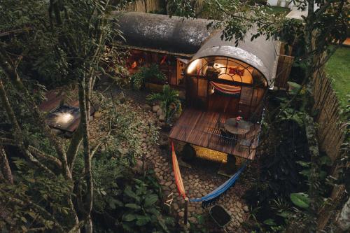 a small tree house with a surfboard in it at Sazagua Hotel Boutique in Pereira