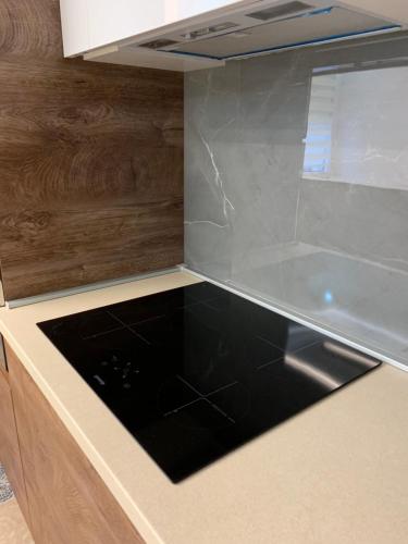a kitchen with a counter with a black counter top at Aleksinac in Aleksinac