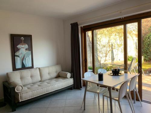 a living room with a couch and a table at LAKE ORTA OPENSPACE garden beach in Pettenasco
