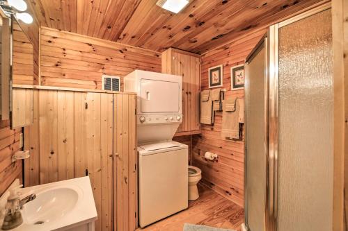 a bathroom with a refrigerator and a sink at Peaceful Mountain City Cabin with Porch and Fire Pit in Mountain City
