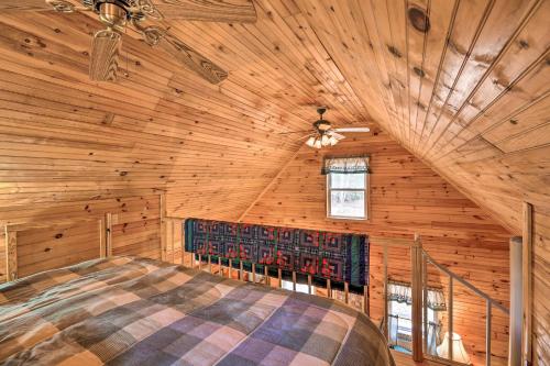 a bedroom in a log cabin with a large bed at Peaceful Mountain City Cabin with Porch and Fire Pit in Mountain City
