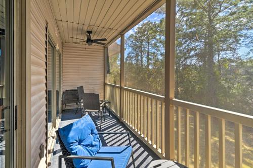 a screened porch with a blue couch and chairs on it at Welcome to After Dune Delight Golf Course Condo! in Pawleys Island