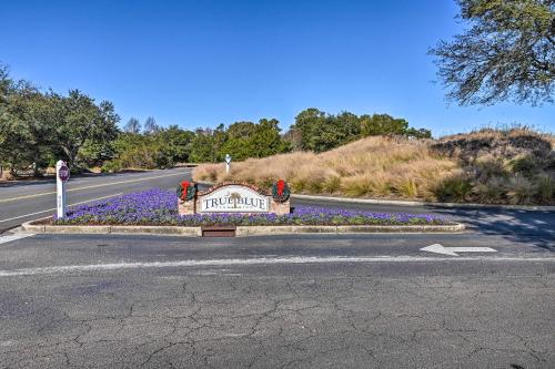 a sign on the side of a road with flowers at Welcome to After Dune Delight Golf Course Condo! in Pawleys Island