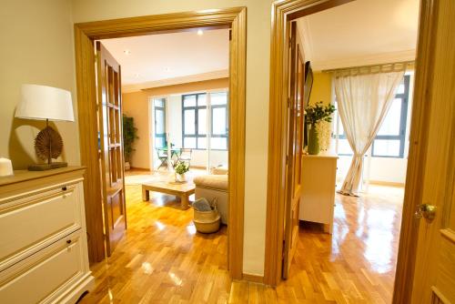 a living room with a door open to a living room at CUENCALOFT CARRETERÍA in Cuenca