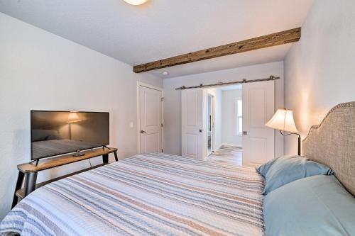 a bedroom with a bed and a flat screen tv at Kenai Home with Fireplace Less Than 10 Mi to Big Eddy! in Kenai