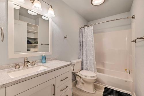a bathroom with a sink and a toilet and a shower at Kenai Home with Fireplace Less Than 10 Mi to Big Eddy! in Kenai