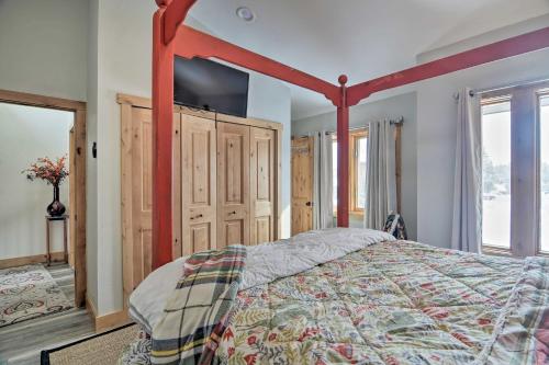 a bedroom with a bed with a red canopy at Cozy Mountain Getaway with Ski Shuttle Access! in Fraser