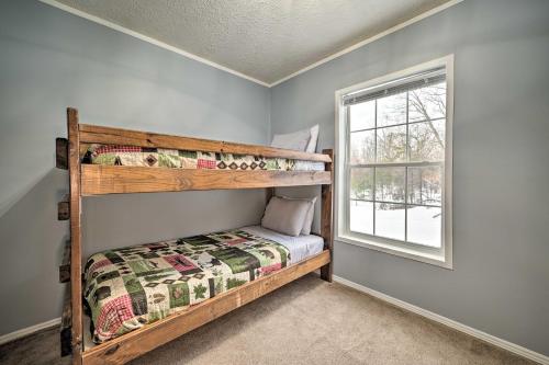 a bedroom with two bunk beds and a window at Spacious Wellston Home Near Hiking and Skiing! in Wellston