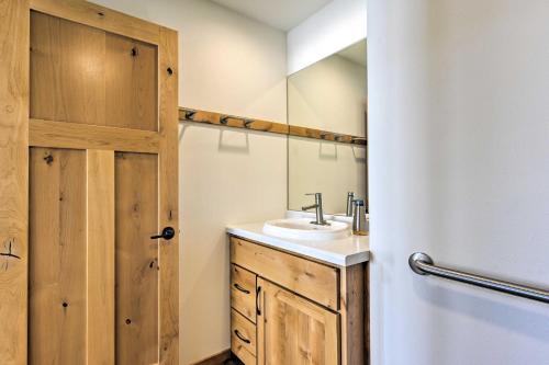 a bathroom with a sink and a mirror at Happys Haven Cabin with Gas Grill and Fire Pit! in Lodi