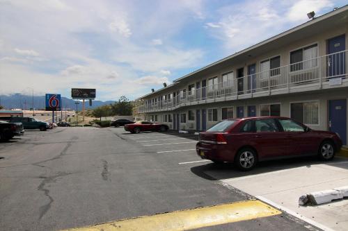 a car parked in a parking lot in front of a motel at Motel 6-Albuquerque, NM - Midtown in Albuquerque