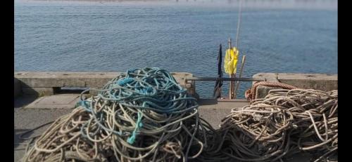 a pile of rope sitting on the side of a boat at Amble Holiday Home in Amble