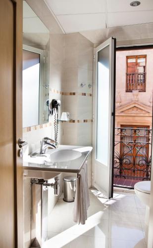 a bathroom with a sink and a toilet at Hotel Soria Plaza Mayor in Soria