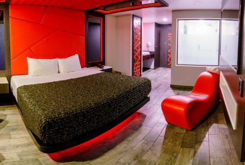 a bedroom with a bed and a red wall at HOTEL PASSION SECRETS VILLAS AND SUITES in Toluca