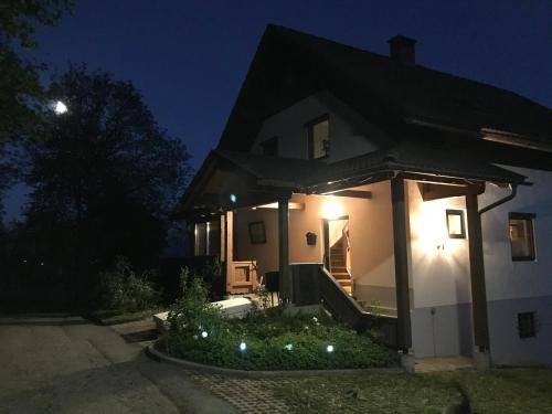 a house with lights on the front of it at night at Haus Romsicht Karinthië in Kerschdorf