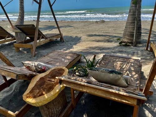 a picnic table and chairs on the beach at Playa Jaguar - Beach Club in Moñitos