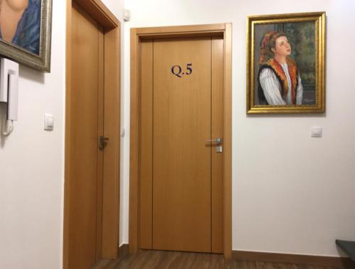 a door with the number on it next to a painting at Sleep In Bucelas in Bucelas