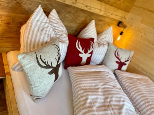 a bed with pillows on it in a room at Tiny House Singer - contactless check-in - Sauna in Ehenbichl
