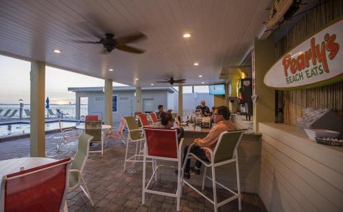 a woman and child sitting at a table in a restaurant at 2 Bed Condo with Balcony Facing Pool and Sunsets! in Tampa