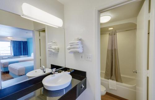 a bathroom with a sink and a mirror at Motel 6-Webster, TX - Houston - Nasa Lake in Webster