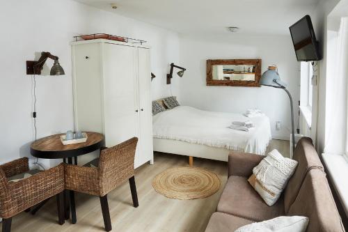 uma sala de estar com um sofá e uma cama em Guest House Aquarius em Zandvoort