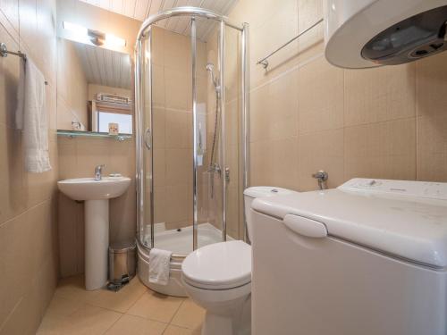 a bathroom with a toilet and a shower and a sink at Sea view Two bedroom Family Apartment with pool - Sunset Ivanovići in Becici