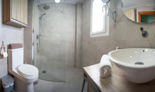 a bathroom with a toilet and a sink and a shower at Valdelagrana Sunset Apartment in El Puerto de Santa María