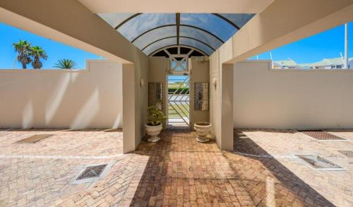 an open hallway with a brick floor and a ceiling at Cascades Self-Catering Apartments in Summerstrand