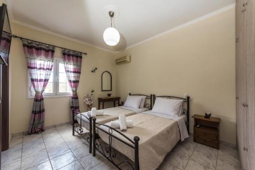 Katil atau katil-katil dalam bilik di Kanelos Garden House